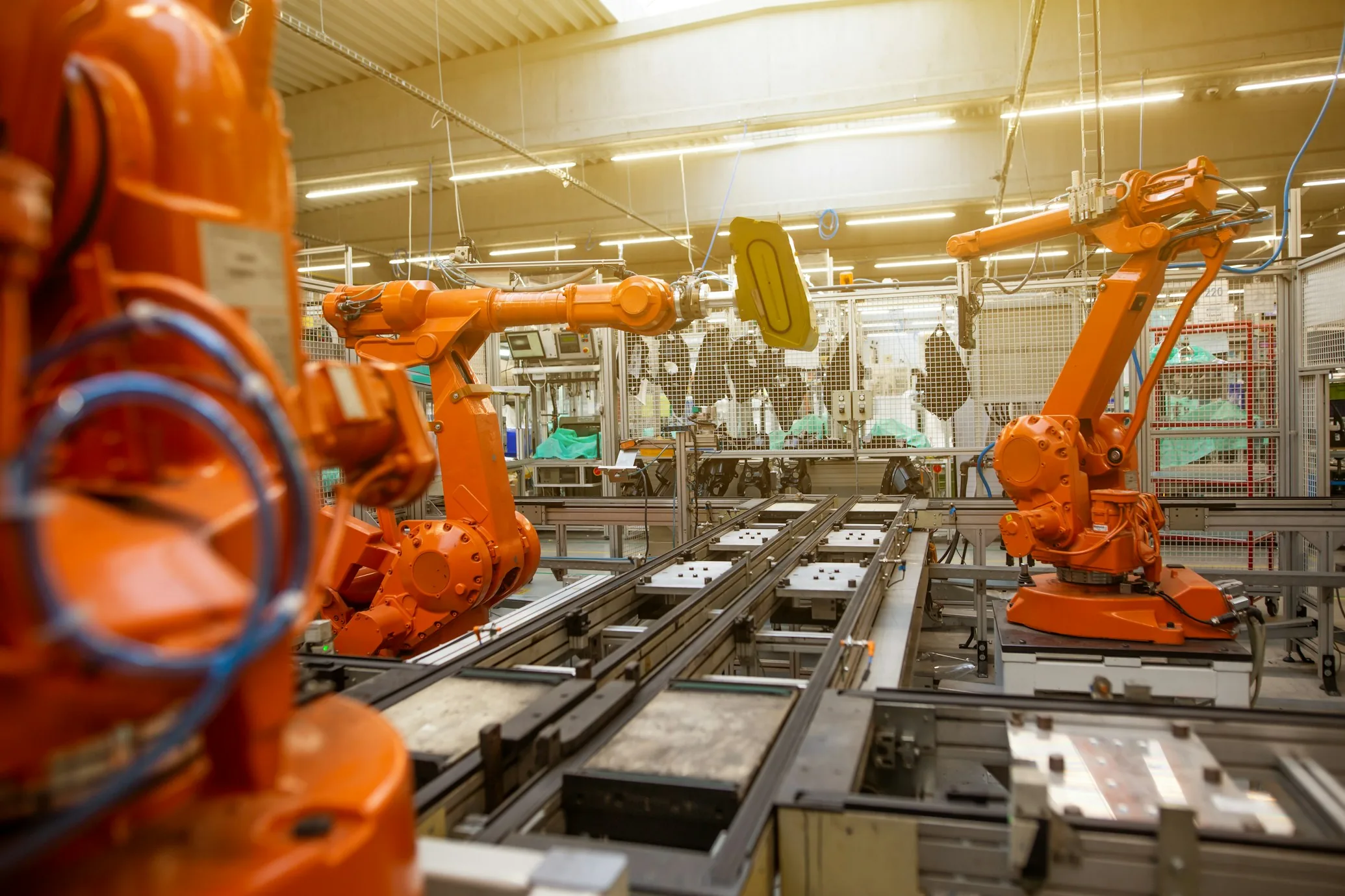 Industrial robots on a production line; illustrative industry photograph